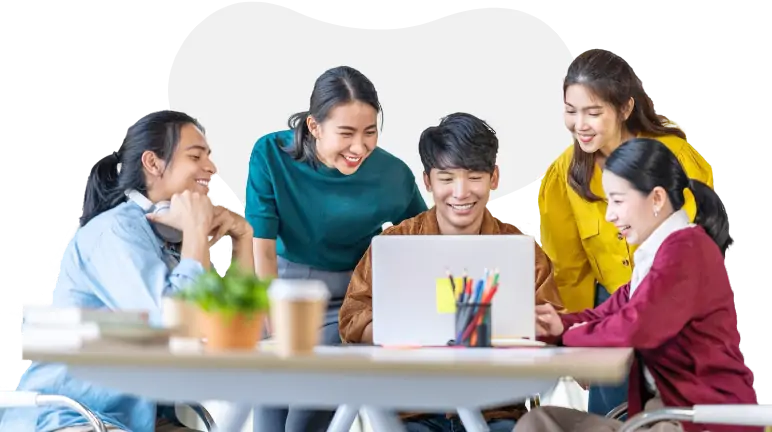 A group of young individuals discussing and looking at laptop