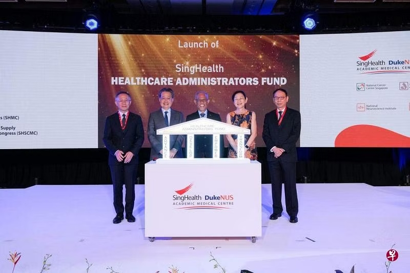 a group of people standing in front of a podium