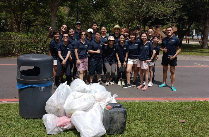 A group of people posing for photo after a beach clean up