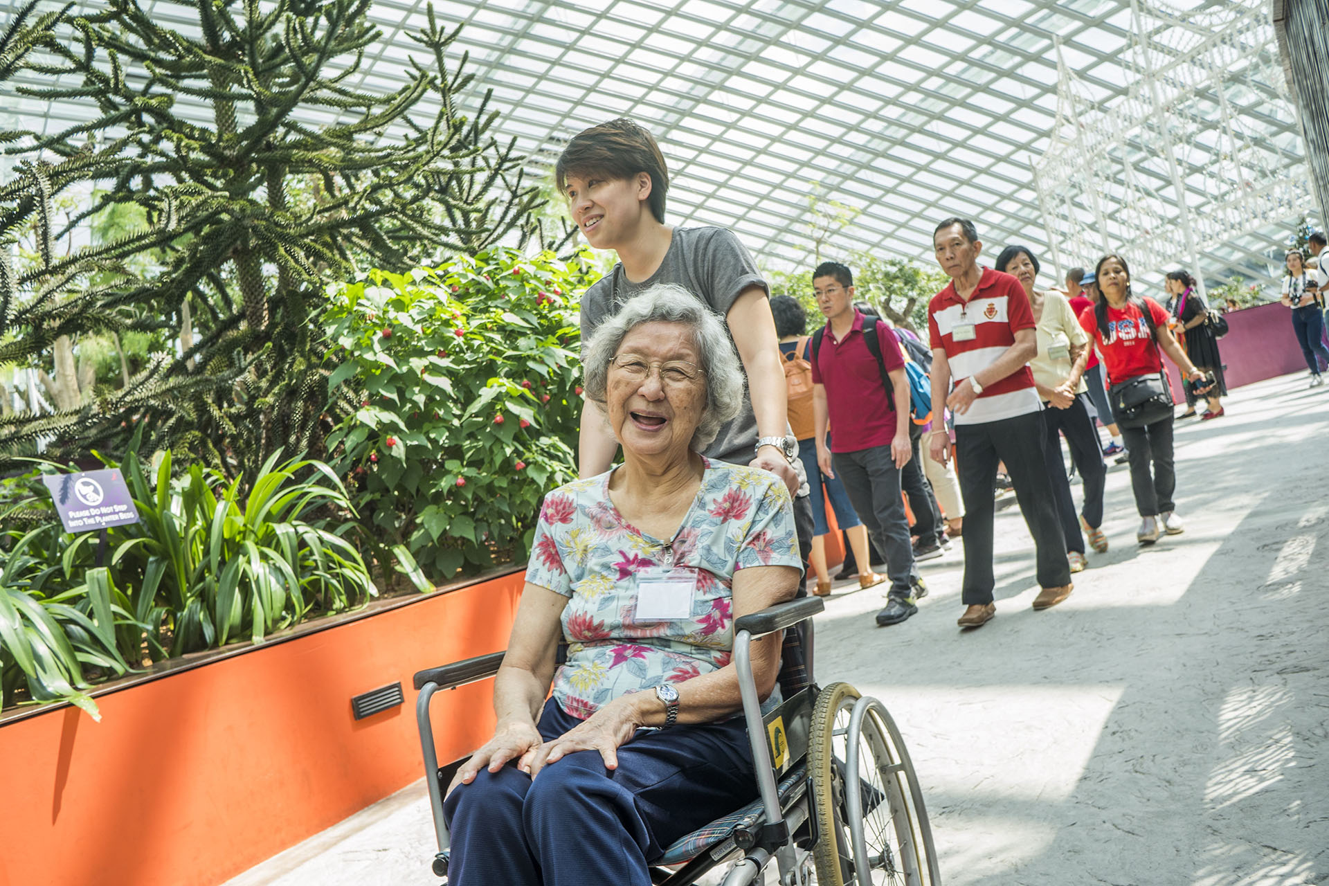 A lady pushing a wheelchair bound lady at cloud forest