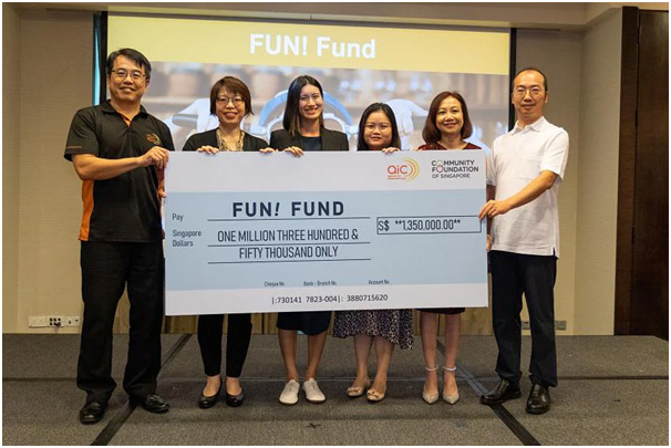 a group of people holding a large check