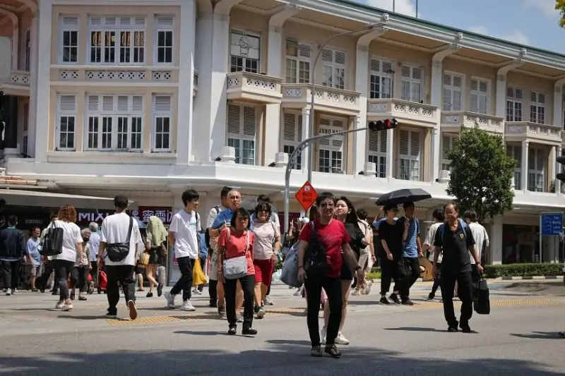 Pedestrians walk crossing a road