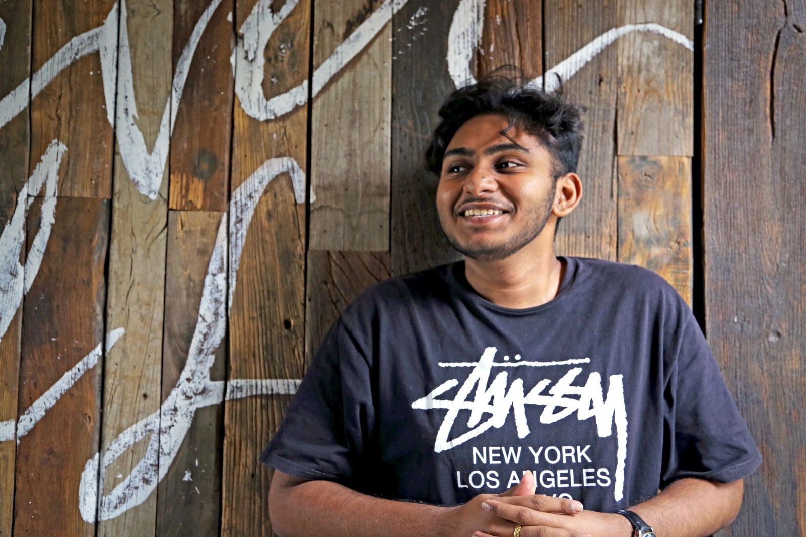 a portrait of a man with a wooden background