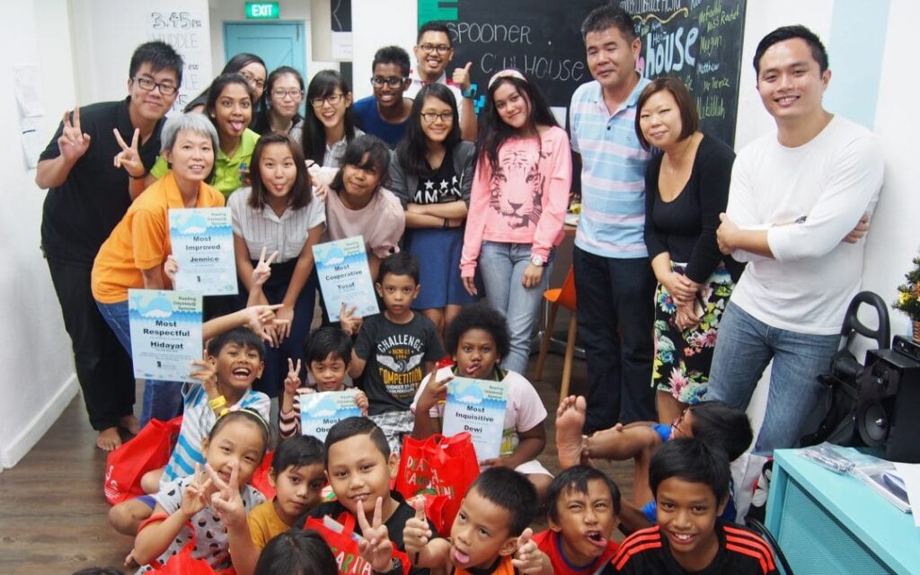 a group of adults and children posing for a picture