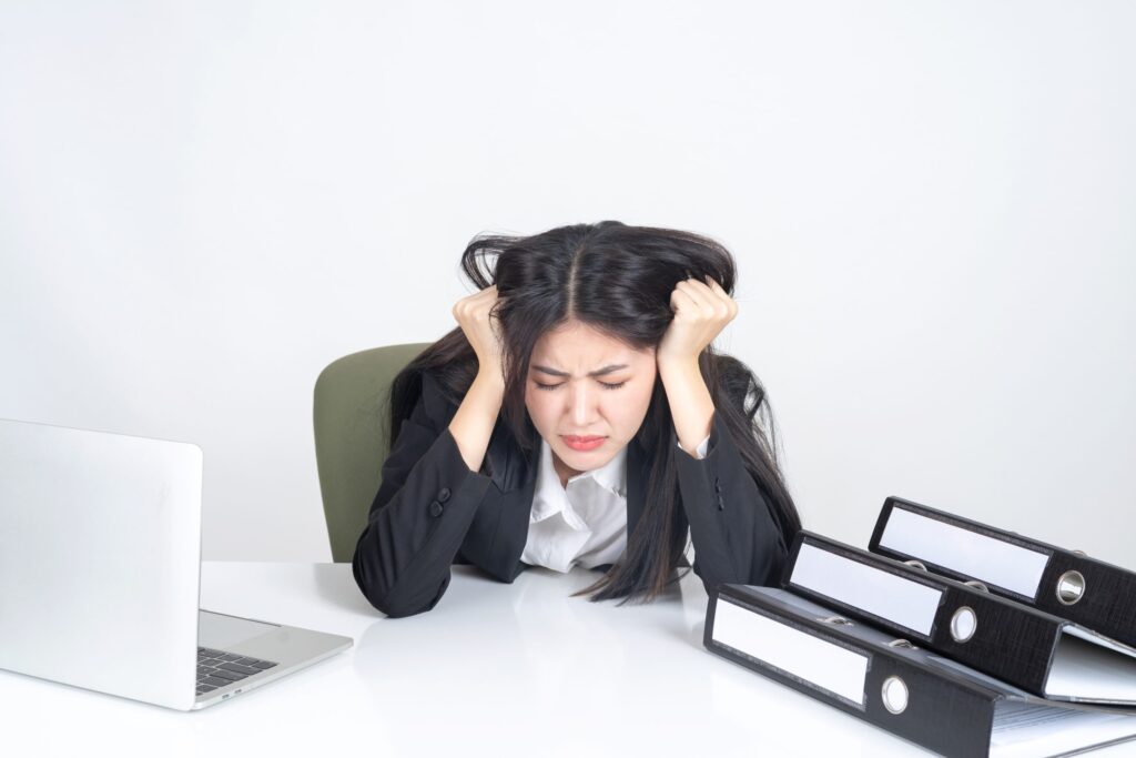 stressed woman with files and laptop