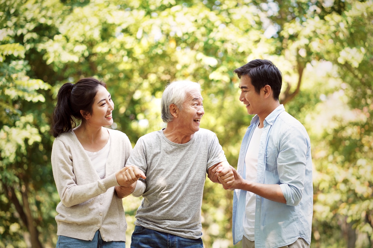 two young people helping an elderly