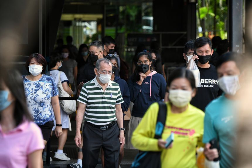 a group of people wearing face masks walking in on the streets